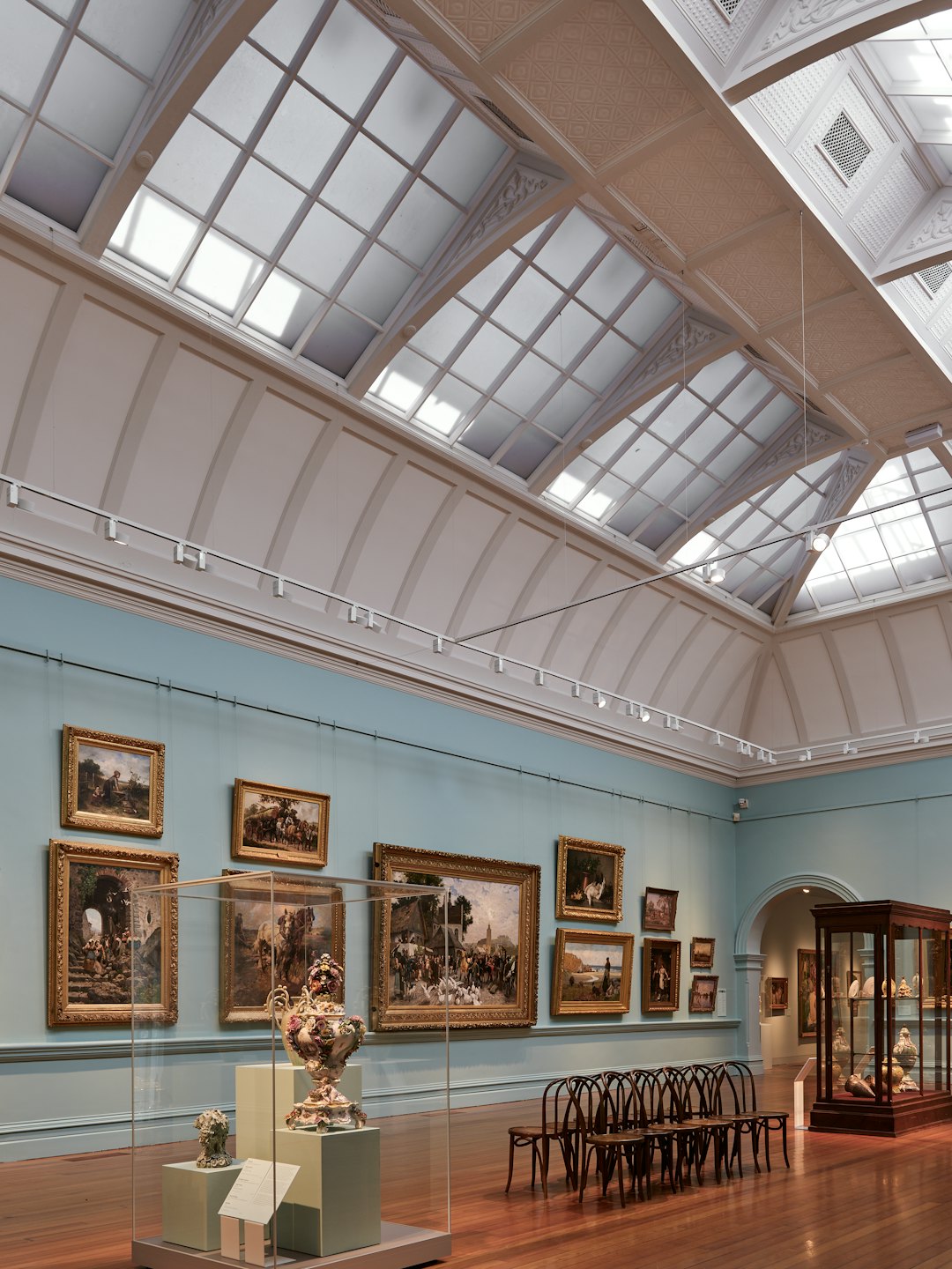 Art gallery with paintings and sculptures on display.